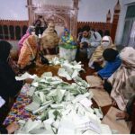 Polling officials counting votes during General Election 2024.