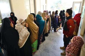 A security personnel standing alert outside a polling station during General Election-2024.
