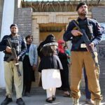 A security personnel standing alert outside a polling station during General Election-2024.