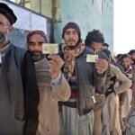 People standing in queue in front of polling station to cast their vote during General Election-2024