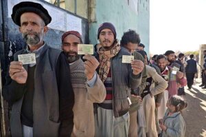 People standing in queue in front of polling station to cast their vote during General Election-2024
