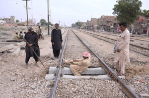 Railway workers are busy in repairing railway track near Railway Station during maintenance work.