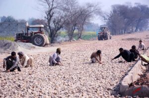 Labourers busy in construction of Abdullah Pur Jhumra Road Flyover during development work in the city.