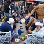 Volunteers distributing free food among deserving people in Sadar Bazar.