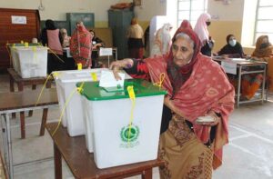 A senior citizen casting her vote in a polling station during General Elections 2024.
