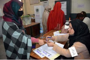 A senior citizen casting her vote in a polling station during General Elections 2024.