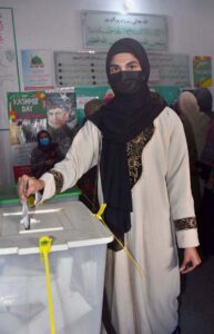 A senior citizen casting her vote in a polling station during General Elections 2024.