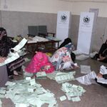 Polling staff counting votes in a polling station at Postal Colony during General Elections-2024