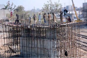 Labourers busy in construction of Abdullah Pur Jhumra Road Flyover during development work in the city. 