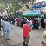 A large number of people in queue outside a polling station at Al –Hilal Housing Society during General Elections 2024