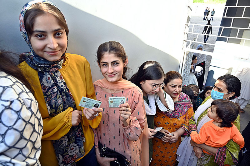 A large number of people in queue outside a polling station at Al –Hilal Housing Society during General Elections 2024