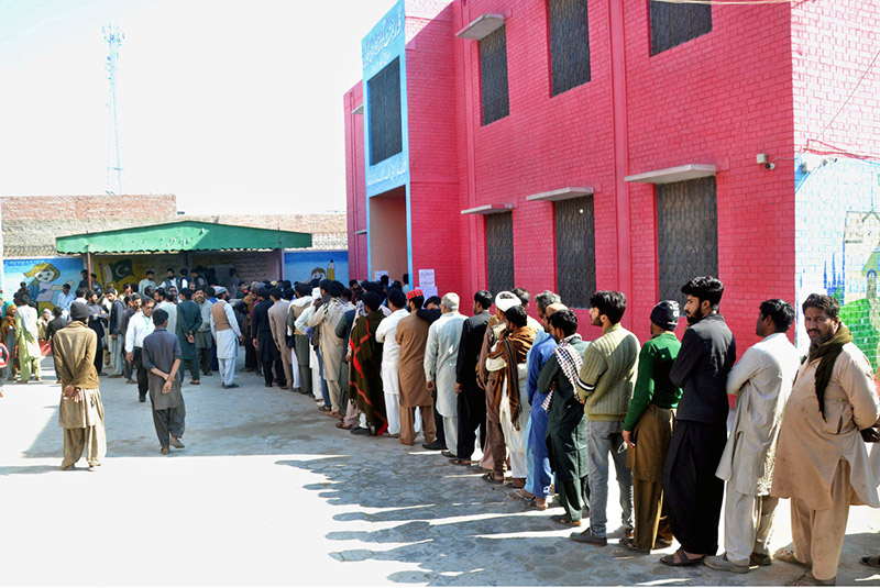 A large number of people in queue to cast their vote in a polling station during General Election-2024