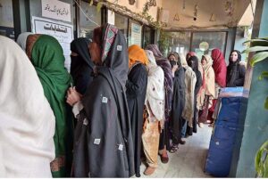 People standing in queue in front of polling station to cast their vote during General Election-2024