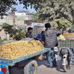 Vendors displaying sweet item (gur) to attract the customers at General Bus Stand Road.
