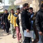 A large number of people submitting visa forms for Korea at Manpower office.