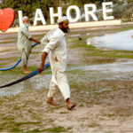 Workers of PHA watering flowers and plants in a local park