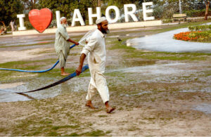 Workers of PHA watering flowers and plants in a local park