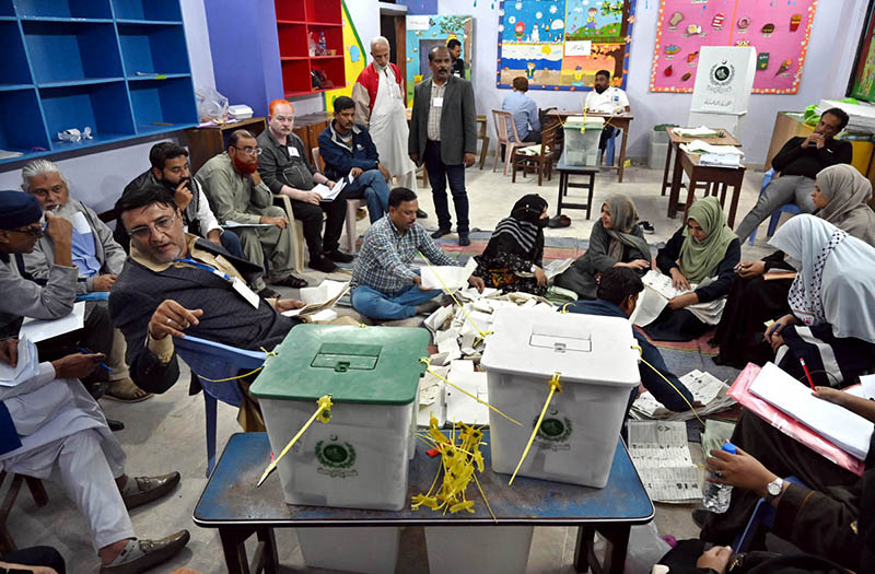 Polling staff opens ballot boxes in presence of poling agents for counting votes during General Elections 2024