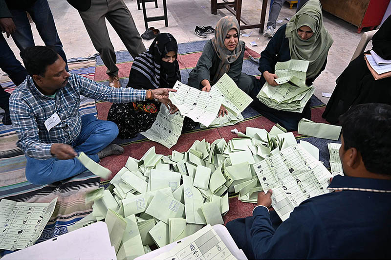 Polling staff opens ballot boxes in presence of poling agents for counting votes during General Elections 2024