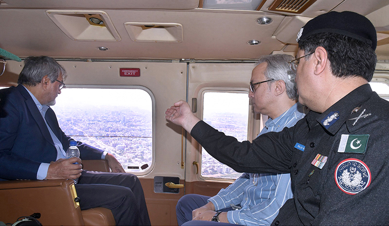 Caretaker Sindh Chief Minister Justice (R) Maqbool Baqar takes aerial view of on-going polling process in the city