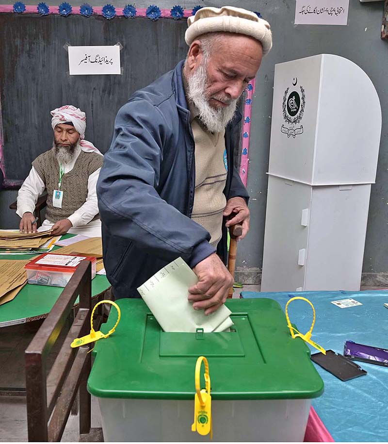 Polling agents searching the name of voter in the voter list outside polling station during General Election-2024
