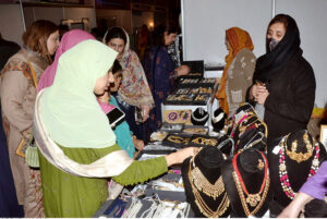 Visitors taking interest in the displayed stuff on a stall during the Bleu fair organized by the Women Chamber of Commerce