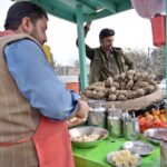 A vendor selling sweet potatoes at his roadside set up at Jail Road