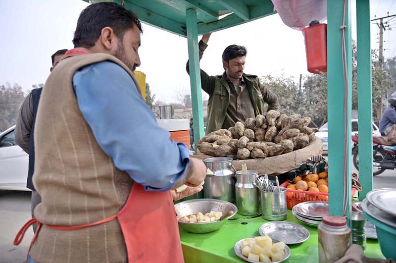 A vendor selling sweet potatoes at his roadside set up at Jail Road