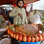 A vendor busy in frying ‘Tawa Kaleji’ for customers at his roadside setup.