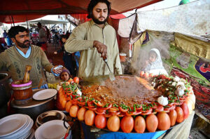  A vendor busy in frying ‘Tawa Kaleji’ for customers at his roadside setup.