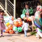 A vendor displayed colorful balloons to attract the customers at the roadside