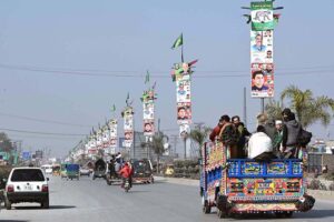 View of different political parties posters and banners displayed on street lights in preparation of General Election-2024 in Provincial Capital.