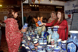 Visitors taking interest in the displayed stuff on a stall during the Bleu fair organized by the Women Chamber of Commerce