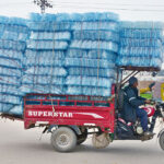 A tri-cycle rickshaw holder on the way at Latifabad loaded with plastic bottles to deliver in a local market