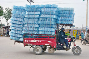 A tri-cycle rickshaw holder on the way at Latifabad loaded with plastic bottles to deliver in a local market