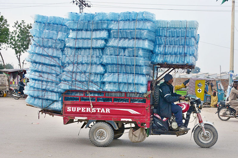 A tri-cycle rickshaw holder on the way at Latifabad loaded with plastic bottles to deliver in a local market