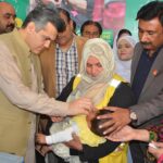 Deputy Commissioner Nair Abdullah Sheikh is administering Polio Drops to a child during the inauguration of 7 Days Anti-Polio Campaign at Allied Hospital