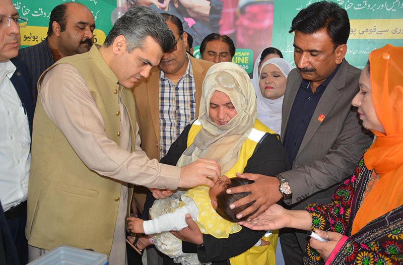 Deputy Commissioner Nair Abdullah Sheikh is administering Polio Drops to a child during the inauguration of 7 Days Anti-Polio Campaign at Allied Hospital