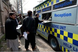 Traffic warden making driving licenses through DL-Van for journalists in front of Press Club.