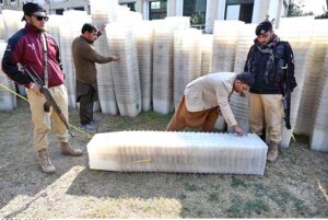 Workers of the Election Commission Office sorting ballot boxes to be sent to polling stations for the upcoming General Elections-2024 at Qayyum Sports Complex.
