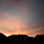 n attractive view of sunset on mountain in city.