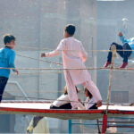 Children enjoying jump on trampoline at vendors’ roadside setup