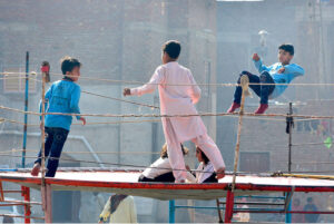 Children enjoying jump on trampoline at vendors’ roadside setup
