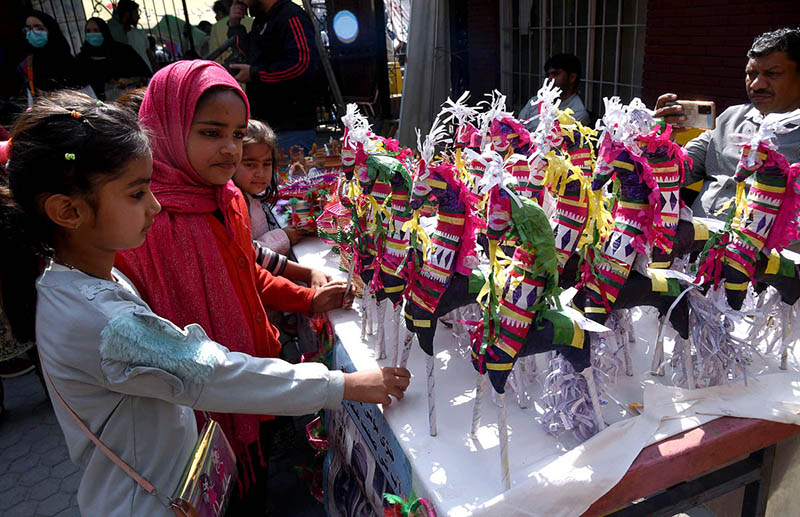 Children viewing traditional toys on a stall during Punjabi Language Day at the Press Club