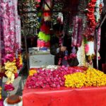 A vendor displays flower bouquets to attract the customers at Raja Bazaar