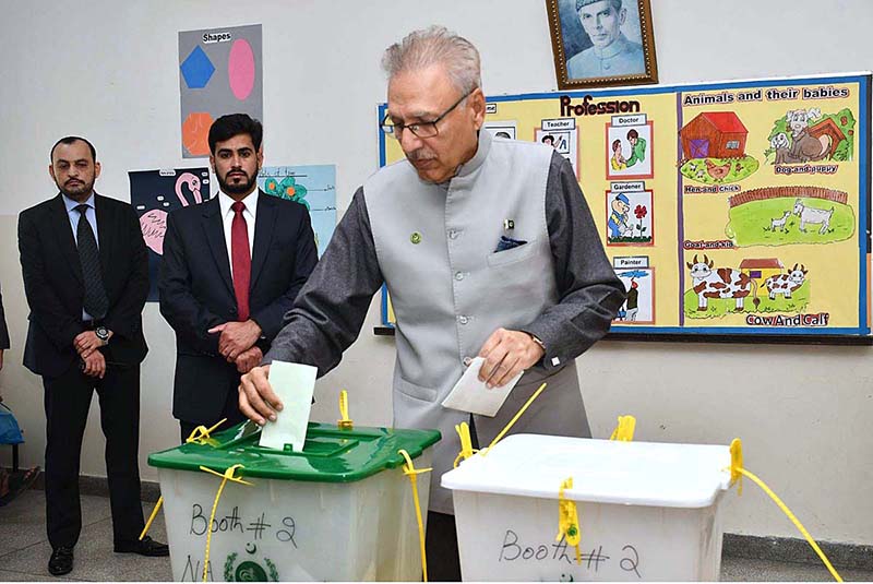 President Dr. Arif Alvi waiting to receive ballot paper in polling station during General Election-2024
