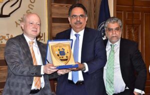 President Chamber of commerce Abdul Ghafoor Malik presenting a shield to Dr. Rudiger Lotz, Consul General at SCCI