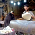 Vendor prepares Chapati Naan for customers at Fawara Chowk