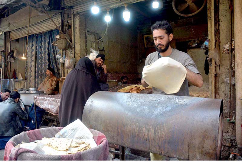 Vendor prepares Chapati Naan for customers at Fawara Chowk