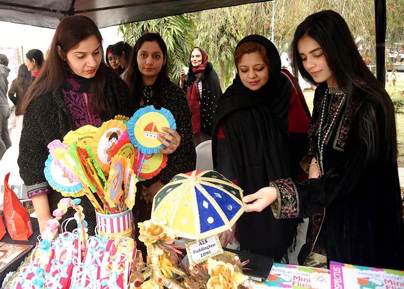 A craftsman is making a horse model by hand on the occasion of Winter Festival at Al Hamra Cultural Complex